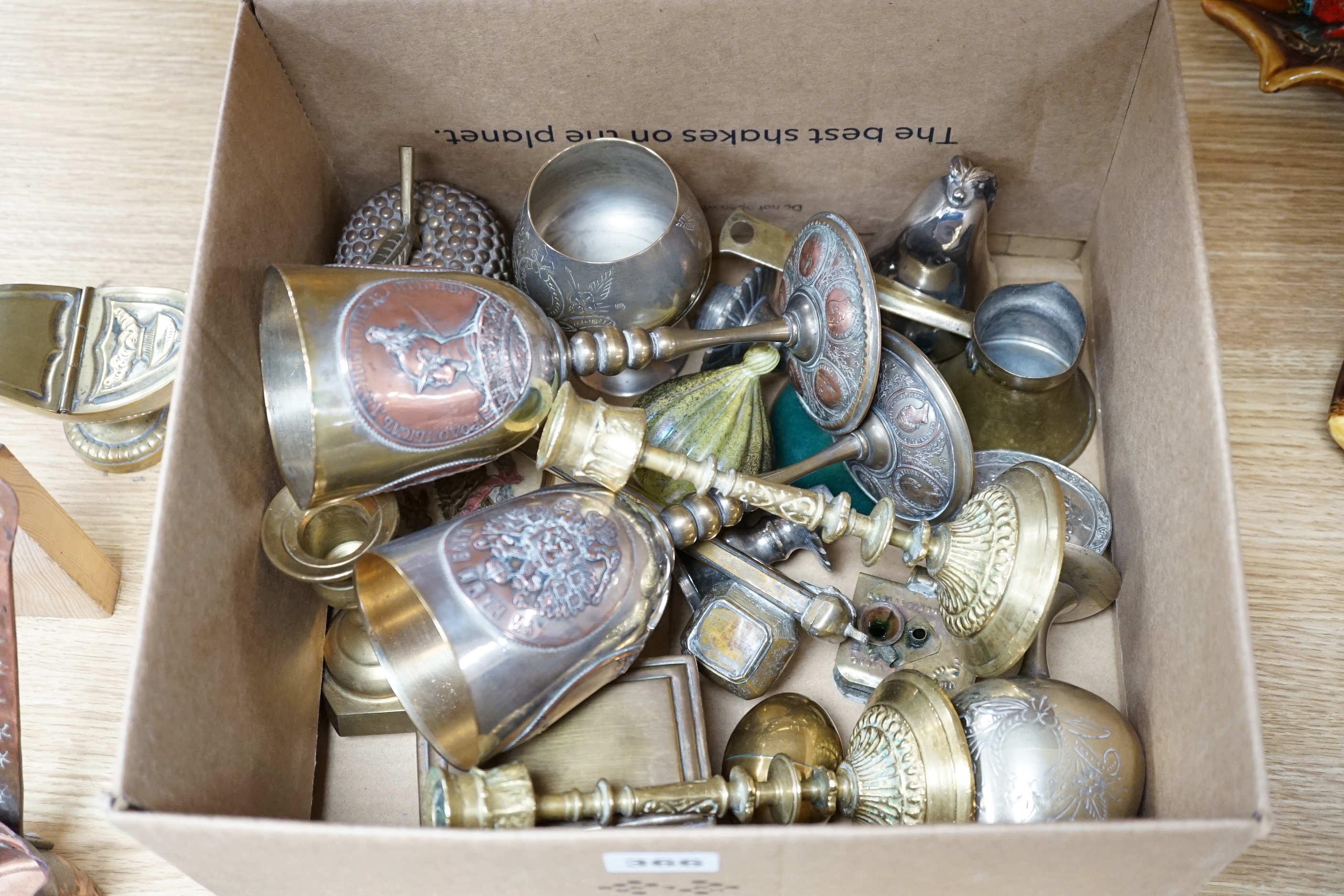 A group of mixed metalware including a pair of brass candlesticks, a brass bound book slide, iron keys, etc.
